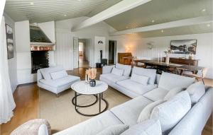 a living room with a white couch and a table at Lovely Home In Koppang With Kitchen in Koppang