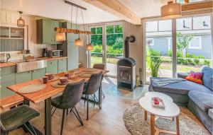 a kitchen and living room with a table and a couch at 2 Bedroom Stunning Home In Zerpenschleuse in Berg