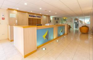 an office lobby with a large island in the middle at El Marques Palace by Intercorp Group in Puerto de Santiago