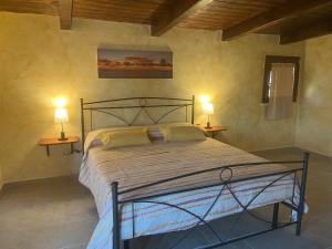 a bedroom with a bed with two lamps on two tables at B&B Around the World in Villa San Giovanni