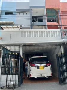 a white car is parked inside of a garage at Piano Private House in Ban Kohong