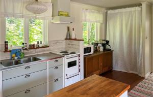 a kitchen with a sink and a stove top oven at 2 Bedroom Beautiful Home In Löderup in Löderup