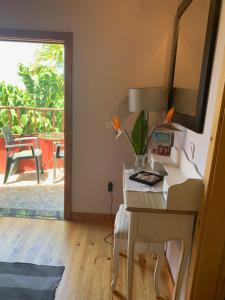 a room with a desk with a mirror and a table at Waves Song - Cottage in Porto Moniz