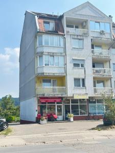 un edificio alto con una tienda delante en Doboj Apartman, en Doboj