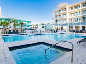 a swimming pool in front of a building at Sea Glass #201 in Gulf Shores