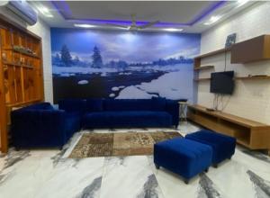 uma sala de estar com sofás azuis e uma televisão em Muhammad homes&land em Islamabad