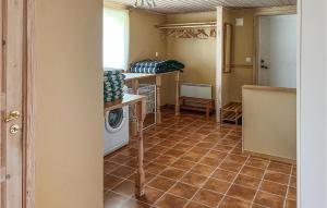a laundry room with a washer and dryer at Gorgeous Home In Vittsj With House A Panoramic View in Vittsjö