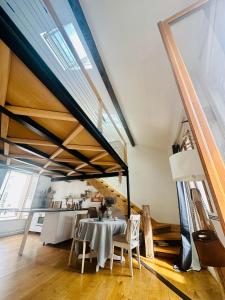 a dining room with a table and some windows at Le Cocon Parisien in Paris