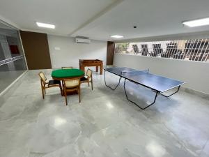 a room with two tables and chairs and a green table at Spazzio Diroma com acesso ao Acqua Park todos os dias in Caldas Novas +43 photos