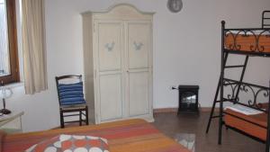 a bedroom with a bed and a ladder and a closet at B&B Supramonte in Orgosolo +11 photos