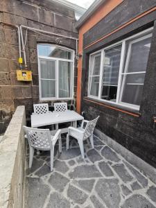 a white table and chairs on a patio at Hotel Elen in Gyumri