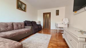 a living room with a couch and a table at Apartament Bogdan in Gura Humorului