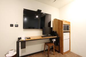 a room with a desk with a television on the wall at 31page in Seoul