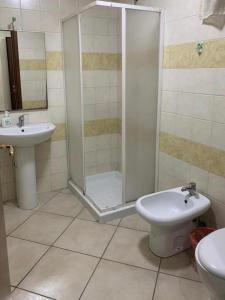 a bathroom with a shower and a toilet and a sink at Crisan B&B Affittacamere in Nola