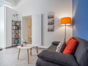 a living room with a couch and a table at Loveflat - scopri Ferrara in bicicletta in Ferrara