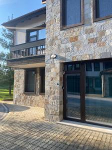 a building with a glass door on the side of it at Vacation house in Pravets Hyatt Regency golf resort in Pravets