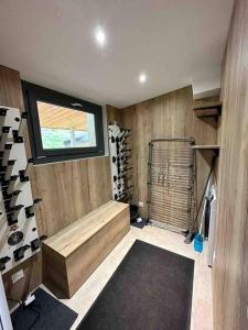 a room with a sauna with a window and wine bottles at Très bel appart avec vue 6 personnes Alpe d Huez in LʼHuez