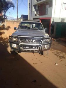 a silver truck parked on a dirt road at Appartements Andrian Location in Antananarivo