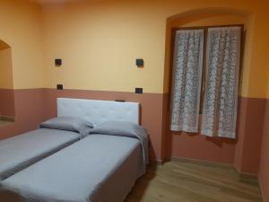 a bedroom with two beds and a window at Albergo Jolanda in Diano Marina