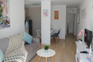 a living room with a couch and a table at Canaima 308 in Puerto Rico de Gran Canaria