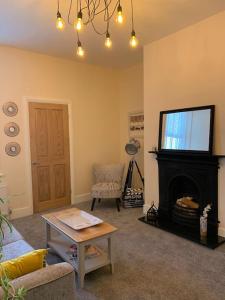 a living room with a fireplace and a tv at Newly Renovated Flat with Free Parking in Walker Gate