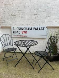 two chairs and a table in front of a road sign at Newly Renovated Flat with Free Parking in Walker Gate