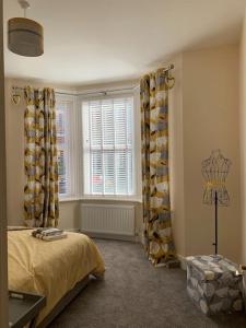 a bedroom with a bed and a window with curtains at Newly Renovated Flat with Free Parking in Walker Gate