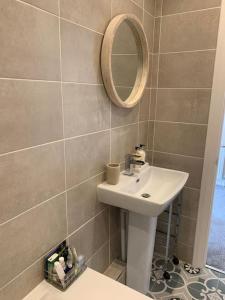 a bathroom with a sink and a mirror at Newly Renovated Flat with Free Parking in Walker Gate