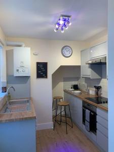 a kitchen with a counter and a clock on the wall at Newly Renovated Flat with Free Parking in Walker Gate