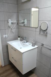 a bathroom with a white sink and a mirror at Canaima 308 in Puerto Rico de Gran Canaria