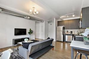 a living room with a couch and a kitchen at 1BR Prime and Comfy Apt with In-Unit Laundry - Lake 302 in Chicago