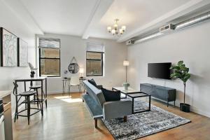 a living room with a couch and a table at 1BR Prime and Comfy Apt with In-Unit Laundry - Lake 302 in Chicago