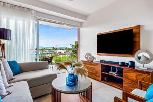 a living room with a couch and a tv at D'Toscana Residencial # 305 in Nuevo Vallarta 