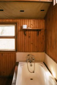 een bad in een kamer met een raam bij Kelora Bush Camp in Hoedspruit