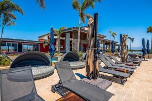 a row of chaise lounge chairs and umbrellas at D'Toscana Residencial # 305 in Nuevo Vallarta 