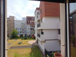 a view from a window of an apartment building at gattopastro in Milan