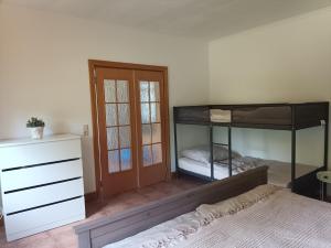 a bedroom with two bunk beds and a dresser at Naturnahe Ferienwohnung 
