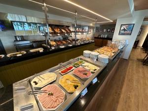 a buffet line with many different types of food at Atlantic Ocean Residence in Fortaleza +57 photos