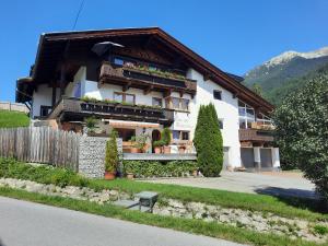 a building with flowers on the balconies of it at Haus am Römerweg in Lermoos