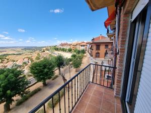 a balcony with a view of a street and trees at El Carmen in Toro