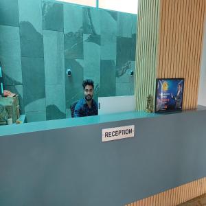 a man sitting at a reception counter in an office at Shankar Residency, Akkalkot in Akalkot