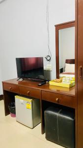 a wooden dresser with a mirror and a dresser with a mirror at ริเวอร์ไซด์ อพาทเมนต์ in Udon Thani +5 photos