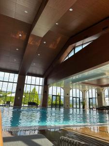 a large swimming pool in a building with windows at Vacation house in Pravets Hyatt Regency golf resort in Pravets