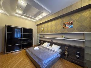 a bedroom with a bed and a large window at Sahil Lux in Baku