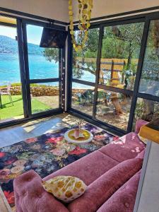 a living room with a couch and a view of the water at 5D in Murter