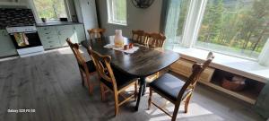 a dining room table and chairs in a kitchen at Lyngtun in Viksdalen