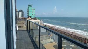 a view of the ocean from the balcony of a building at MercuryFM 105 House Colombo 3 - Schofield pl 3-2 in Colombo