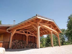 a large wooden barn with a pile of logs at Chalet Valmorel, 7 pièces, 15 personnes - FR-1-291-793 in Valmorel