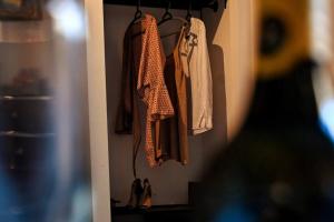 a closet with clothes hanging on a wall at Cittadella Suite in Victoria