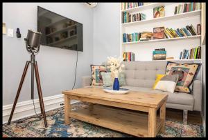 a living room with a coffee table and a couch at 4BR 10 mins walk to Central Park! in New York